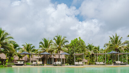 Obraz premium =swimming pool in the jungle of Thailand, aerial view of a swimming pool in the jungle of Thailand with lounge chairs by the pool
