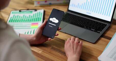 Closeup of woman with cloud 99 percent download download on mobile smart phone. Storing data on cloud drive - Powered by Adobe