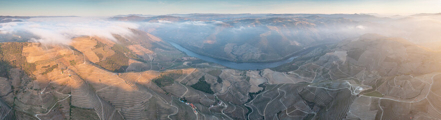 Aerial view of the terraced vineyards in romantic sunset in the Douro Valley near the village of...