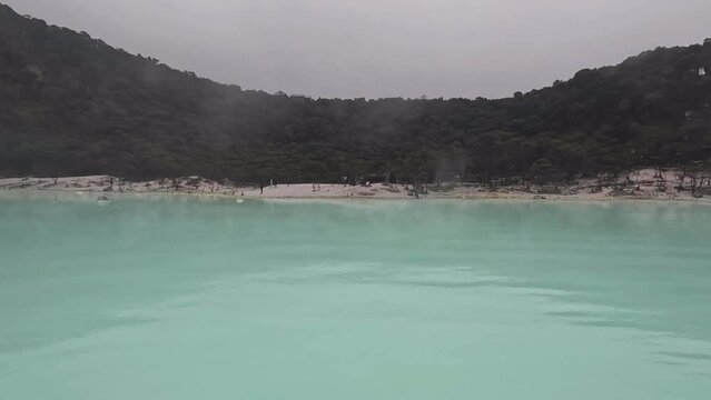 Kawah Putih or White Crater inside a volcanic crater in Ciwidey, West Java, Indonesia with a green sulfur lake.