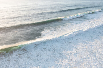 Aerial view of the white beach with waves 
Big ocean wave
Versatile use. Holiday concept