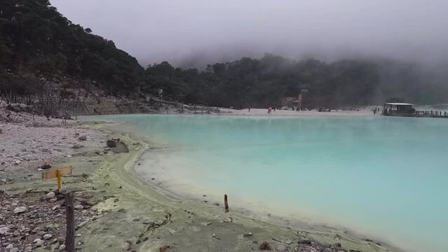 Kawah Putih or White Crater inside a volcanic crater in Ciwidey, West Java, Indonesia with a green sulfur lake.