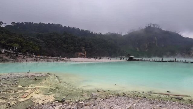 Kawah Putih or White Crater inside a volcanic crater in Ciwidey, West Java, Indonesia with a green sulfur lake.