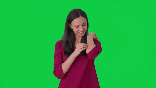 Happy Indian woman removing the bandage Green screen