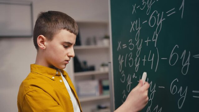 Schoolboy having difficult task, puzzled with a math problem, school education
