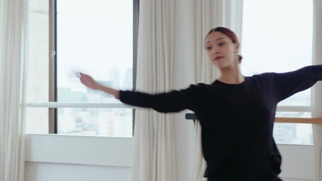 Young talented ballerina dancing and practicing classical ballet movements on a rehearsal in studio. Tilt-down shot