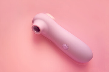 Purpe sex toy with vacuum suction on the pastel pink background