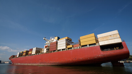 MARITIME TRANSPORT - A container ship sails with cargo to the port
