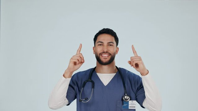 Medical nurse, man and face with pointing up with decision and solution in studio space with approval. Doctor, healthcare and professional with promotion and happy from sale with white background