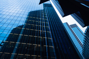 Modern abstract reflections in glass fronted commercial office buildings in the financial district...