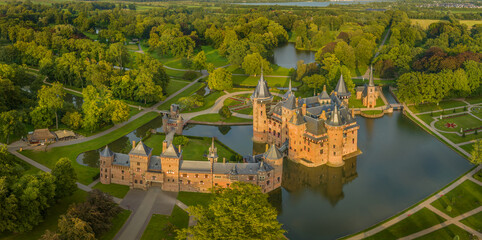 View of castle De Haar enchanting with  typical towers and a fairy tale-like facade, which gleams on bright days and lush landscaping gardens. Neo-Gothic Kasteel de haar. - obrazy, fototapety, plakaty