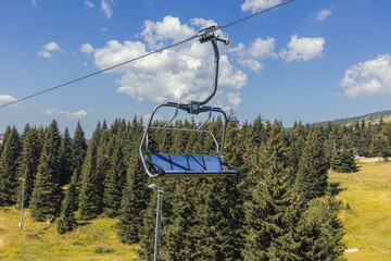 Chairlift on mountain landscape at summer day