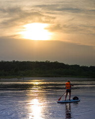 Paddle boarding during sunset on the Vistula river