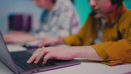 Closeup of excited boys playing video game on laptops, teenage lifestyle, gaming