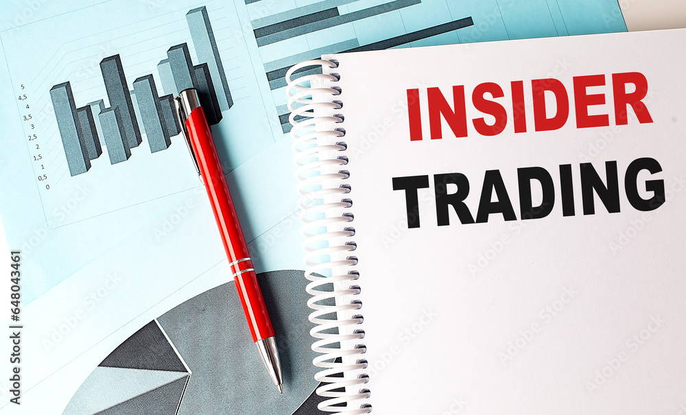 Poster insider trading text on a notebook with pen on a chart background