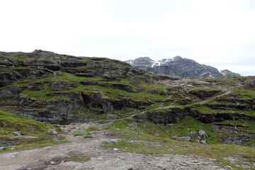 Fototapeta na wymiar Mountain landscapes of Norway. The top of the mountain range, mountain lake. Hiking to Troltunga