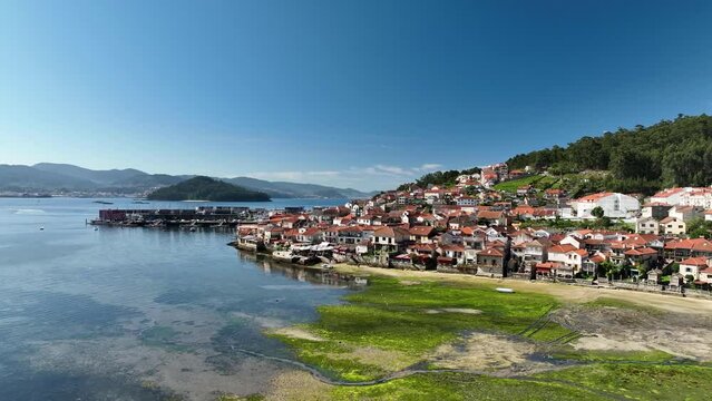 Orbiting View of Combarro: Harbor, Village, Beach, and Sea on a sunny day.