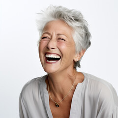 Obraz na płótnie Canvas A closeup photo of a elderly senior model woman laughing and smiling with clean teeth on white background