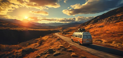 Fototapeten A van traveling at sunset in nature on a canyon path for a road trip to adventure and freedom © mozZz
