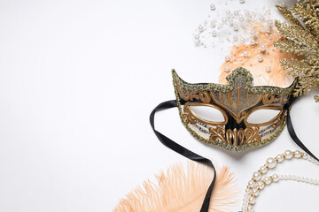 Carnival mask and decor on white background, space for text