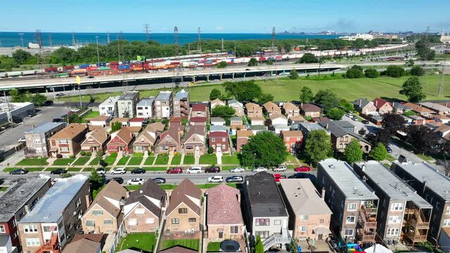 Old Neighborhood Outside Of Chicago, Illinois. Aerial Truck Shot Of Houses And Homes With A Highway And Train Tracks Heading Towards Downtown Chicago In Background. View Of Lake Michigan.