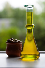 Container with extra virgin olive oil and a bowl with olives