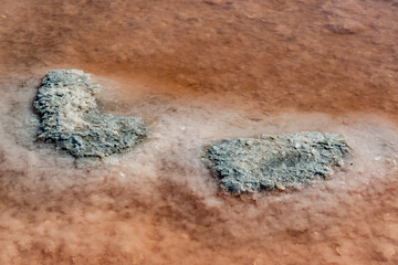 Salt Lake. Self-settling sodium chloride salt on rocks near the shore. Hypersaline water