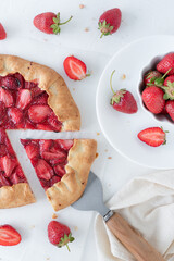 Galette with strawberries and ice cream on a white background. Summer dessert made from berries and ice cream.