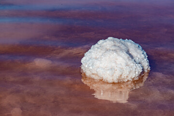 Salt Lake. Self-settling sodium chloride salt on rocks near the shore. Hypersaline water