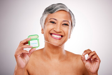 Senior woman, floss and studio portrait for transformation, beauty and healthy mouth by white...