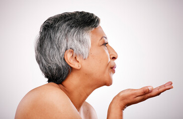 Skincare, mature woman face and blow kiss for anti aging treatment, self care shine or natural...