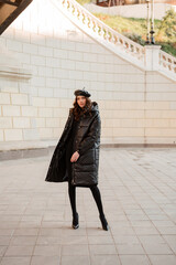 stylish woman in winter autumn fashion trend black puffer coat © mary_markevich