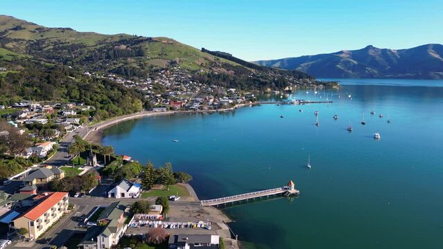 Akaroa, New Zealand: Aerial drone footage of the stunning Akaroa idyllic village in the Banks Peninsula in the Christchurch region of Canter bury in New Zealand south island on a sunny day. 