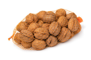 Net with whole walnuts in the shell isolated on white background close up