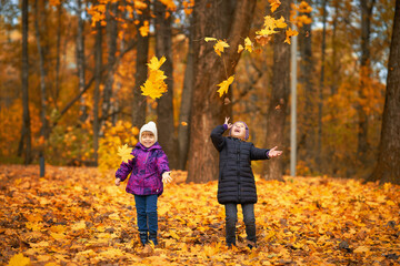 Two children having fun in the autumn forest