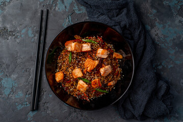 Asian fried wok rice with salmon fish - 648085802
