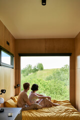 couple enjoying beautiful view on green trees and resting together in country house, serenity © LIGHTFIELD STUDIOS