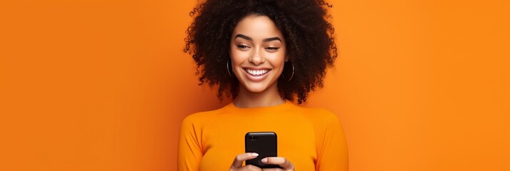 girl with phone on orange background.