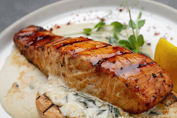 Grilled salmon fillet steak with sauce. Close up