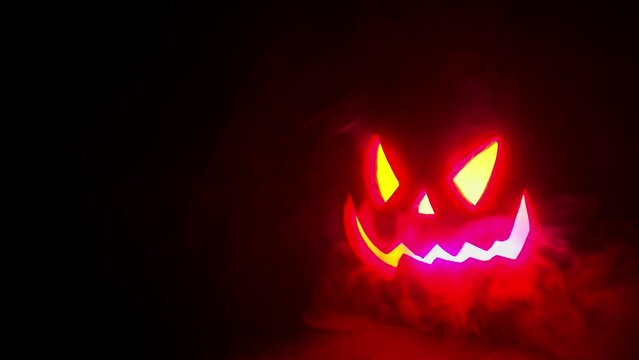 Glowing Jack O Lantern face on black background, lower right corner framing, Halloween or horror background or title asset. 4l