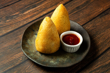 two traditional Brazilian coxinhas. typical fried snack food stuffed with meat and chicken