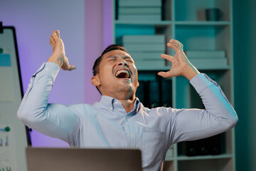 Asian man showing tired and stressed expression in the office, company employee working overtime,...