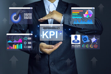 Key performance indicator KPI concept, Businessman holding performance chart dashboard to analysis using business intelligence BI measure personal competency compare on annual target achievement