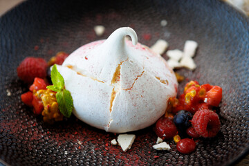 Pavlova berry cake with passion cream, strawberry, meringue. Delicious sweet dessert food closeup served for lunch in modern gourmet cuisine restaurant - 648109897