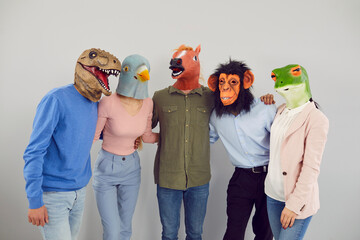 Team of strange people disguised as funny animals. Studio portrait of young men and women wearing...