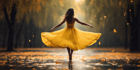 woman dancing in the rain with a yellow dress  in autumn - obrazy, fototapety, plakaty