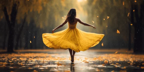 Badezimmer Foto Rückwand woman dancing in the rain with a yellow dress  in autumn © Zanni