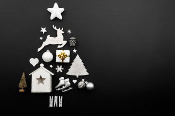 Christmas tree made of decorations on black background