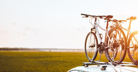 Outdoor Adventure Awaits. Family Car with Bicycles Mounted on Roof Rack. A vehicle with top mounted...