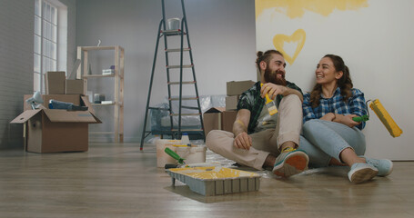 Cheerful young couple in the morning at home. Newlywed caucasian couple are relaxing during...